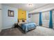 Bedroom with a colorful design featuring a yellow accent wall and blue curtains at 22669 E Tufts Pl, Aurora, CO 80015