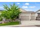 Charming two-story home with a well-manicured front lawn, three-car garage, and inviting front porch at 22669 E Tufts Pl, Aurora, CO 80015