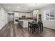 Open-concept kitchen features a large island, modern appliances, and stylish backsplash at 22669 E Tufts Pl, Aurora, CO 80015