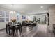 The living room has hardwood floors, a stone fireplace, a black leather couch, and sliding glass doors to the back patio at 22669 E Tufts Pl, Aurora, CO 80015