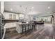Open-concept living space with a kitchen, dining table, hardwood floors, and access to the patio at 22669 E Tufts Pl, Aurora, CO 80015