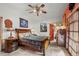 Cozy bedroom featuring a decorative ceiling fan and adjacent bathroom with a red door at 829 Colorado Blvd, Idaho Springs, CO 80452