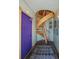 Unique hallway featuring a distinctive purple door and a captivating wooden spiral staircase at 829 Colorado Blvd, Idaho Springs, CO 80452