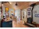 Hallway with wood ceilings, a wood stove and access to the bathroom and stairwell at 829 Colorado Blvd, Idaho Springs, CO 80452