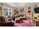 Cozy living room featuring a bay window, comfortable seating, and eclectic decor at 829 Colorado Blvd, Idaho Springs, CO 80452