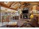 Comfortable living room showcases a wood ceiling, stone fireplace, and TV at 829 Colorado Blvd, Idaho Springs, CO 80452
