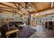 Spacious living room featuring wood-beam ceilings, skylights, tile flooring, and a comfortable leather sofa at 829 Colorado Blvd, Idaho Springs, CO 80452