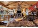 Open living room with vaulted ceilings, stone fireplace, and comfortable seating at 829 Colorado Blvd, Idaho Springs, CO 80452