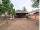 Spacious backyard featuring a partially covered patio and chain link fencing at 2710 Stuart St, Denver, CO 80212
