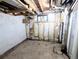 Unfinished basement showing exposed ceiling, utilities, and some peeling paint at 2710 Stuart St, Denver, CO 80212