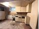 Utility area in basement includes cabinets, sink, and some visible plumbing at 2710 Stuart St, Denver, CO 80212
