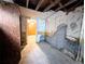 Unfinished basement space with exposed ceiling beams and a glimpse into an adjacent room at 2710 Stuart St, Denver, CO 80212