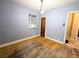 Bedroom featuring hardwood floors, window, and a door at 2710 Stuart St, Denver, CO 80212