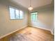 Bedroom with two windows, hardwood floors, and neutral walls at 2710 Stuart St, Denver, CO 80212