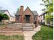 A classic brick home with dark trim and a well maintained yard exudes timeless charm at 2710 Stuart St, Denver, CO 80212