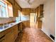 Retro kitchen features wooden cabinets, tile backsplash, and linoleum flooring at 2710 Stuart St, Denver, CO 80212