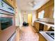 Retro kitchen featuring wood cabinets, tiled backsplash and a ceiling fan at 2710 Stuart St, Denver, CO 80212
