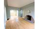 Open-concept living room featuring a fireplace and hardwood floors at 2710 Stuart St, Denver, CO 80212