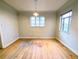 Empty living room with two windows, hardwood floors, and neutral walls at 2710 Stuart St, Denver, CO 80212