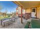 Covered back patio with room for dining and relaxation, featuring comfortable seating at 5420 E 61St Way, Commerce City, CO 80022