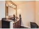 Well-lit bathroom with granite countertops, dark cabinets, and neutral walls at 5420 E 61St Way, Commerce City, CO 80022