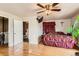 Cozy bedroom with hardwood floors, ceiling fan, an ensuite bathroom and natural light at 5420 E 61St Way, Commerce City, CO 80022