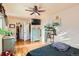 Bedroom features hardwood floors, a large TV, ample closet space, and stylish furniture at 5420 E 61St Way, Commerce City, CO 80022