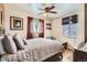 Relaxing bedroom with a ceiling fan, large window, and warm tones throughout at 5420 E 61St Way, Commerce City, CO 80022