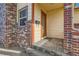 Inviting front entrance with a classic wood door and brick accents at 5420 E 61St Way, Commerce City, CO 80022