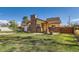 Charming home featuring a brick chimney, well-manicured lawn, and a welcoming front walkway at 5420 E 61St Way, Commerce City, CO 80022