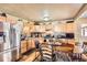 Spacious kitchen featuring wooden cabinets, modern appliances, and a stainless steel refrigerator at 5420 E 61St Way, Commerce City, CO 80022
