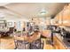 Large kitchen with ample cabinet space, a dining table, and hardwood floors at 5420 E 61St Way, Commerce City, CO 80022