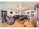 Cozy living room with hardwood floors, plush seating, and elegant decor at 5420 E 61St Way, Commerce City, CO 80022