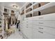 Large walk-in closet with ample shelving and drawers at 7706 S Duquesne Way, Aurora, CO 80016