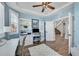 Bright home office with built-in shelving and hardwood floors at 7706 S Duquesne Way, Aurora, CO 80016