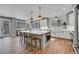 Modern kitchen with island, white cabinets, and hardwood floors at 7706 S Duquesne Way, Aurora, CO 80016