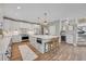 Modern kitchen with large island, stainless steel appliances, and hardwood floors at 7706 S Duquesne Way, Aurora, CO 80016