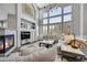 Living room with fireplace and ample natural light at 7706 S Duquesne Way, Aurora, CO 80016