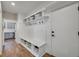 Functional mudroom with built-in bench, storage, and hooks at 7706 S Duquesne Way, Aurora, CO 80016