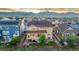 A picturesque aerial view of a home with solar panels and mountain views shows a well-maintained community at 19894 W 94Th Ln, Arvada, CO 80007