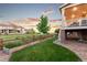 Beautiful backyard with a lush lawn, wood fence, and a covered porch, perfect for relaxing and entertaining at 19894 W 94Th Ln, Arvada, CO 80007