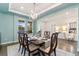 Chic dining space with refined finishes, a modern chandelier, and hardwood floors adds a touch of elegance at 19894 W 94Th Ln, Arvada, CO 80007