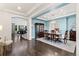 Elegant dining room with modern lighting, a coffered ceiling, and hardwood floors creates a welcoming space at 19894 W 94Th Ln, Arvada, CO 80007