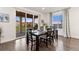 Dining area with dark wood table, seating for six, and sliding doors to outdoor deck at 19894 W 94Th Ln, Arvada, CO 80007