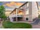 Beautiful home exterior features a covered porch, a spacious lawn, and a walkout basement at 19894 W 94Th Ln, Arvada, CO 80007