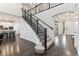 Staircase with dark wood flooring and an adjacent modern kitchen create an open and stylish entryway at 19894 W 94Th Ln, Arvada, CO 80007