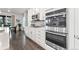 Kitchen with stainless steel appliances, custom white cabinetry, and modern finishes at 19894 W 94Th Ln, Arvada, CO 80007