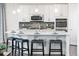 Bright kitchen with stainless steel appliances, an island with seating, and pendant lighting at 19894 W 94Th Ln, Arvada, CO 80007