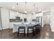 A modern kitchen features a large island with seating and stainless steel appliances at 19894 W 94Th Ln, Arvada, CO 80007