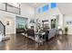Bright living room with a fireplace, hardwood floors, and comfortable seating under high ceilings at 19894 W 94Th Ln, Arvada, CO 80007